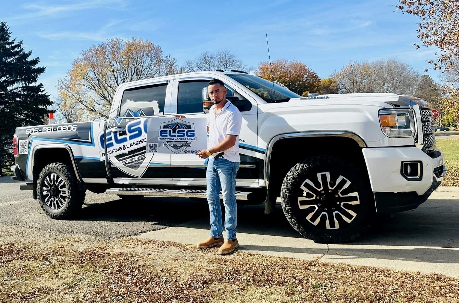 Elvin, next to one of our own ELSG trucks. The shield decal, phone number and QR code are all on the door behind him.